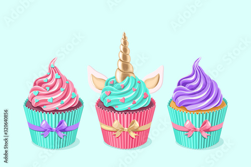 Festive unicorn cupcakes set.  Cake with golden horn and cream on blue background