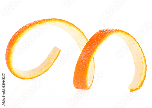 Curly orange peel isolated on a white background, front view.