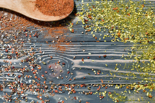 Different seasonings, spices and wooden spoon