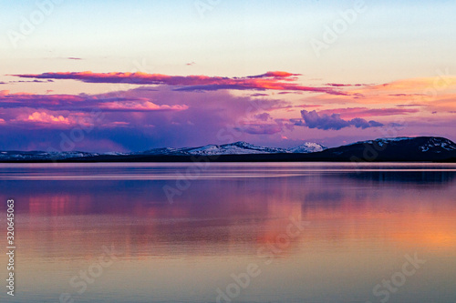Wallpaper Mural Beautiful sunset over Lake Yellowstone with reflection in water and snow capped mountains in the background Torontodigital.ca