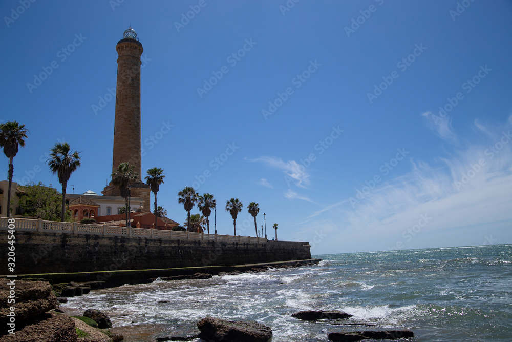 Obraz premium lighthouse on the shore of the Mediterranean in the summer in sunny weather