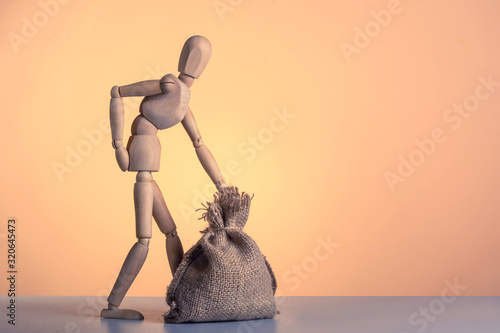 Wooden mannequin  near the tower of cubes with the inscription Posture on orange  background