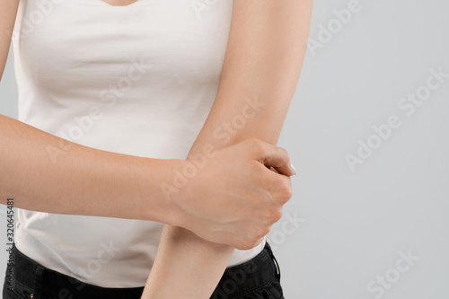 Woman suffering from pain in elbow.