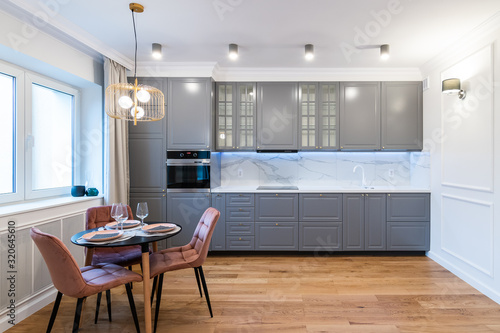 Stylish kitchen interior with dining table and chairs