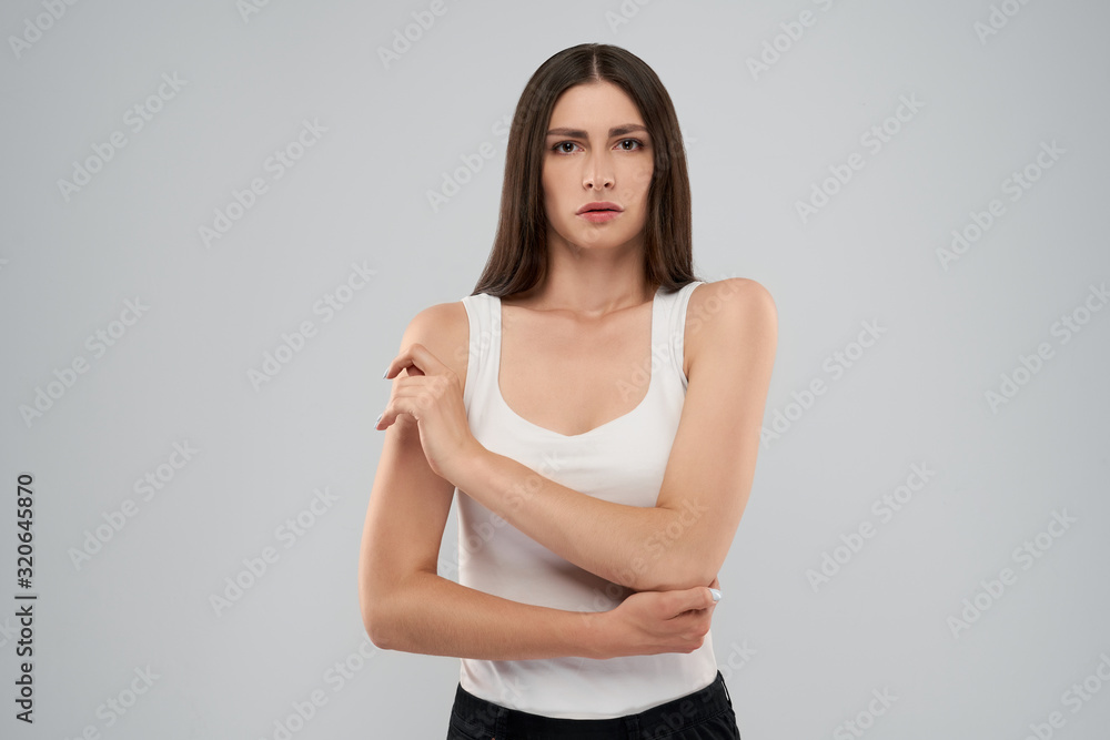 Obraz premium Woman touching elbow because of pain.