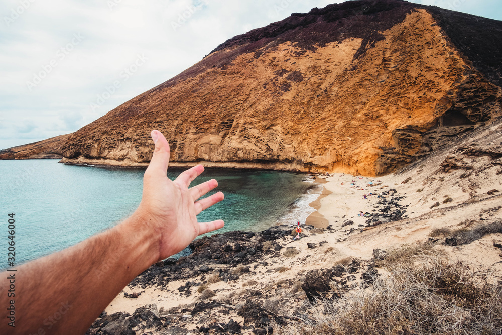 Fototapeta premium hand indicating a heavenly beach