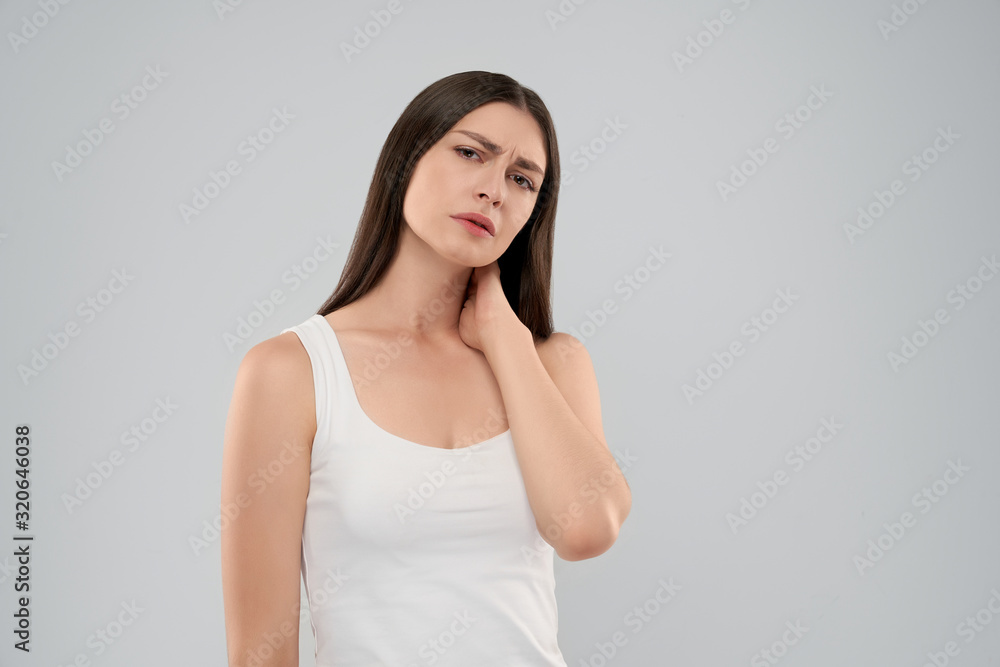 Woman touching neck because of pain. Woman touching neck because of pain.