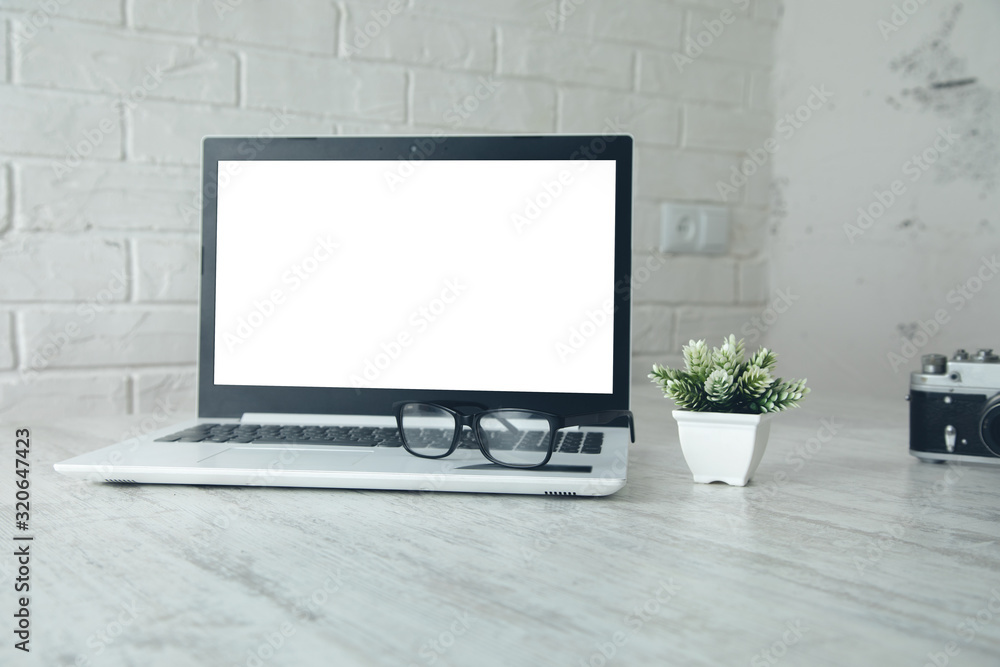 Fototapeta premium camera with glasses and computer on desk