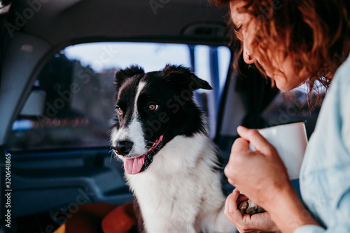 woman and border collie dog in a van. Travel concept © Eva