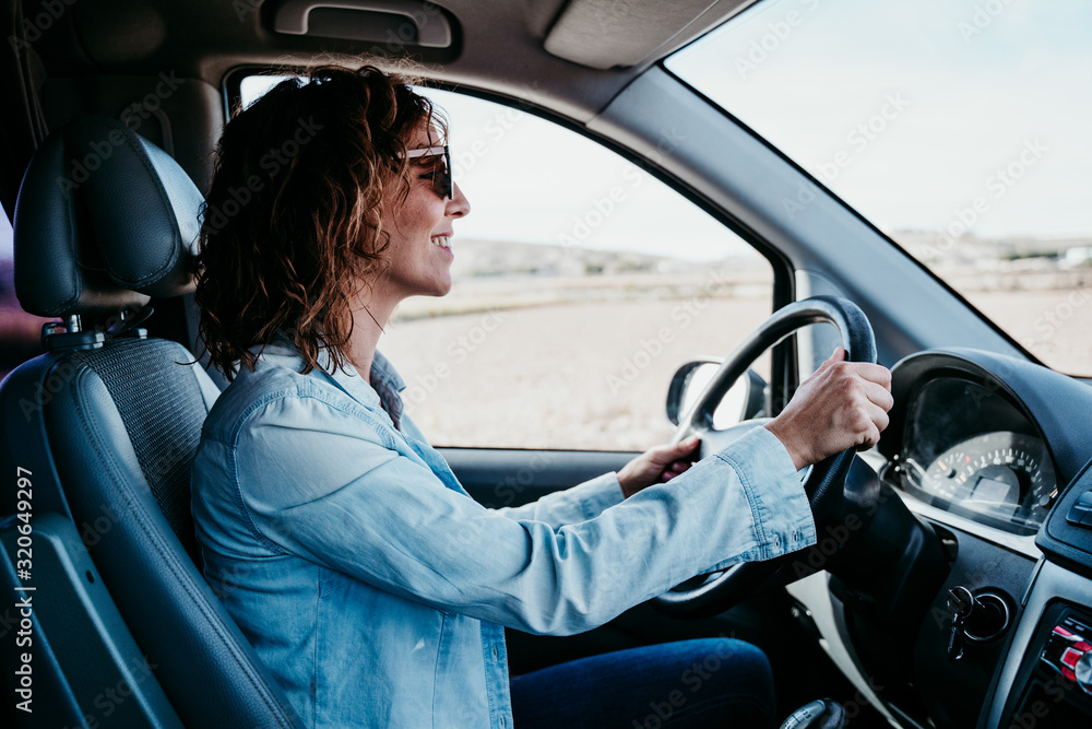 young beautiful woman driving a van. travel concept young beautiful woman driving a van. travel concept