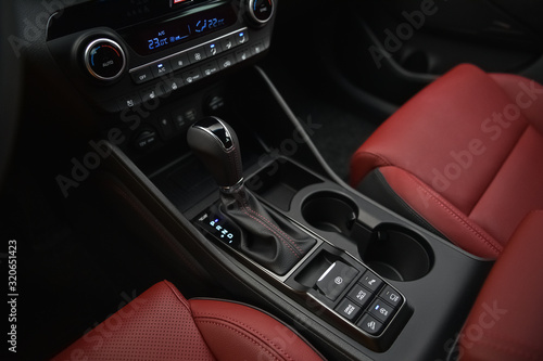Interior of a car. Cup holders and automatic gearbx shifter.