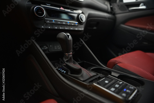 Interior of a car. Cup holders and automatic gearbx shifter.