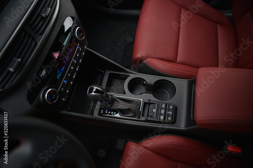 Interior of a car. Cup holders and automatic gearbx shifter.