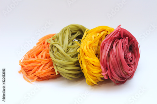 Isolated colored spaghetti nests on a white background.