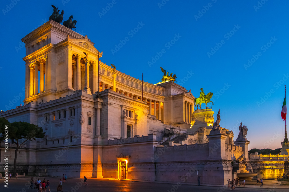 Obraz premium Rome, Italy - Evening view of the Victor Emmanuel II National Monument, known also as Altare della Patria - at the Piazza Venezia square and the Palatine Hill