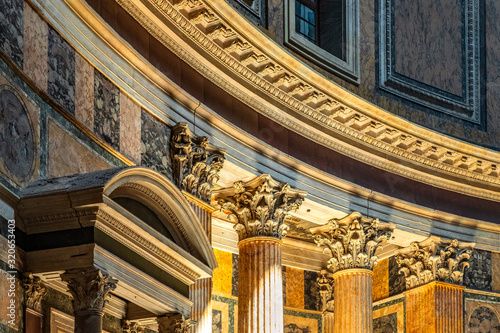 Rome, Italy - Interior of Roman Pantheon ancient temple, presently catholic Basilica, with its reach decorations, arches and colonnades covered with golden and colorful paintings