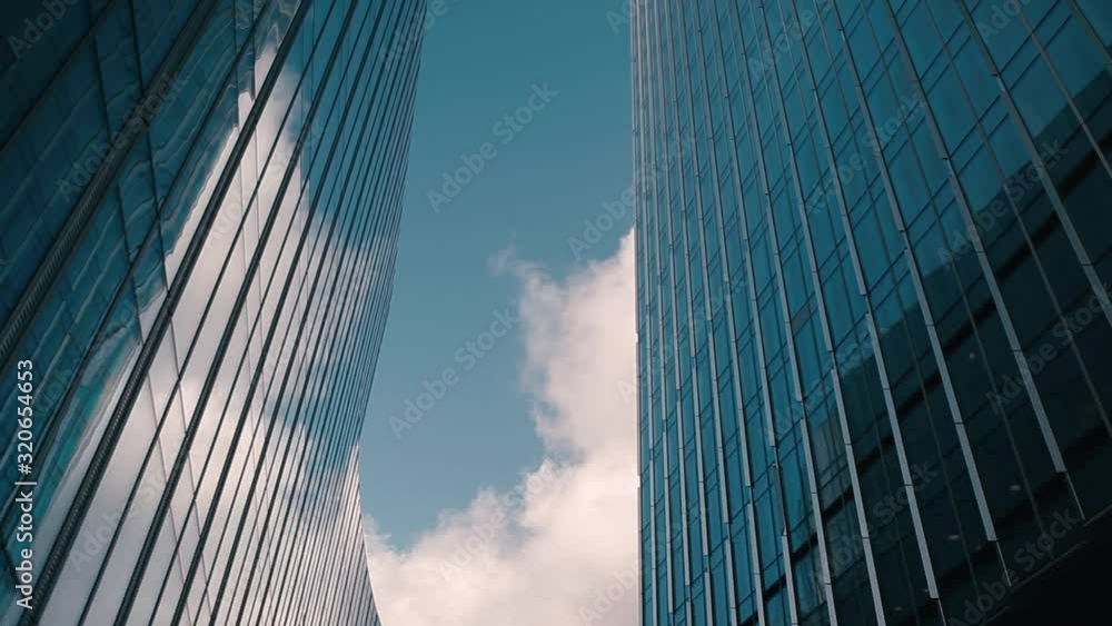 Time lapse of clouds reflecting onto the glass of a large office building. Modern Business Office Buildings with Glass Reflection. Time lapse of clouds reflecting onto the glass of a large office building. Modern Business Office Buildings with Glass Reflection.