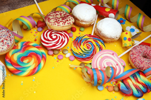 candies with jelly and sugar and streamers. colorful array of different childs sweets and treats.