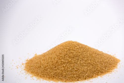 Brown sugar on a white background, healthy sugar used for cooking or desserts.