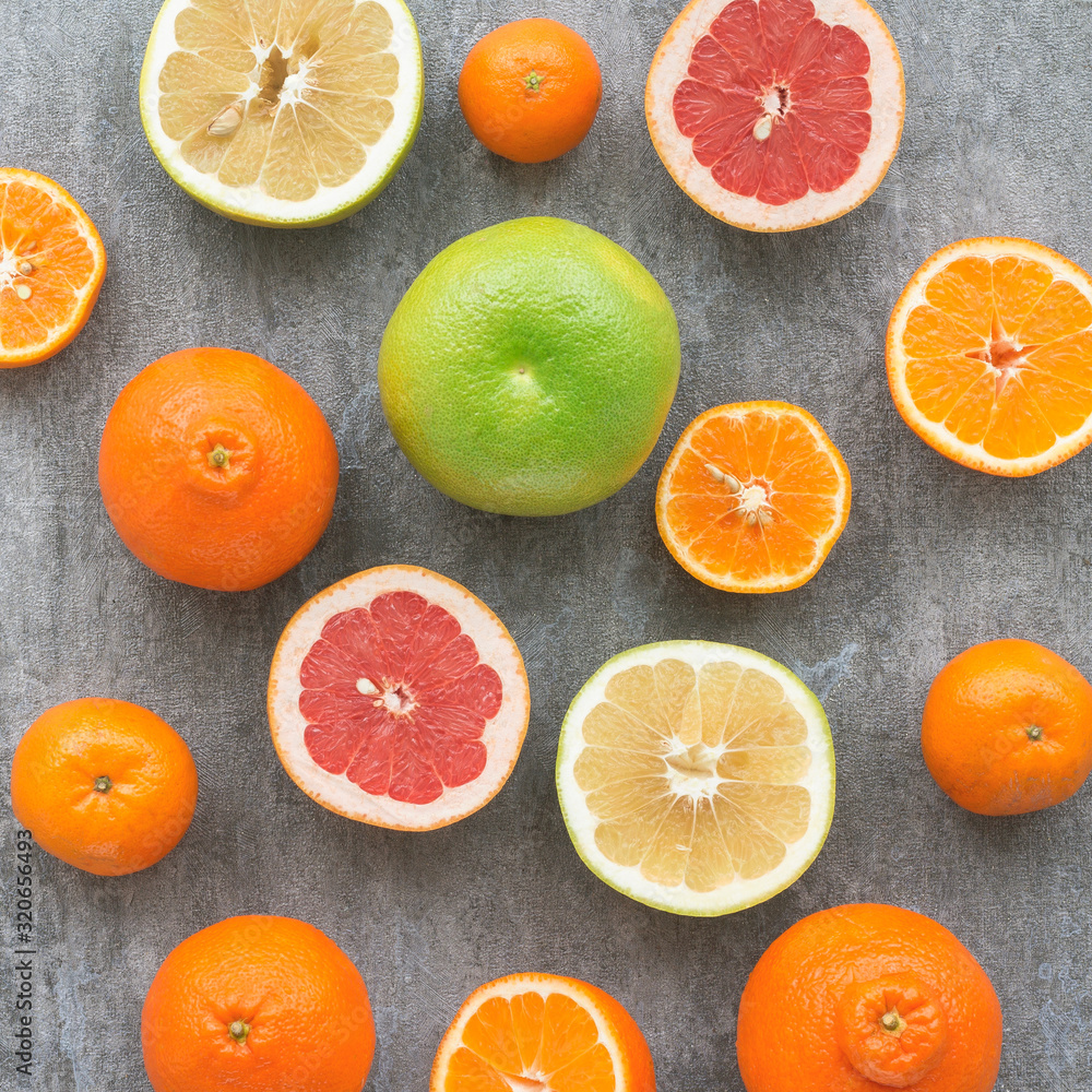 Fresh citrus fruit on dark gray background, flat lay, top view Fresh citrus fruit on dark gray background, flat lay, top view