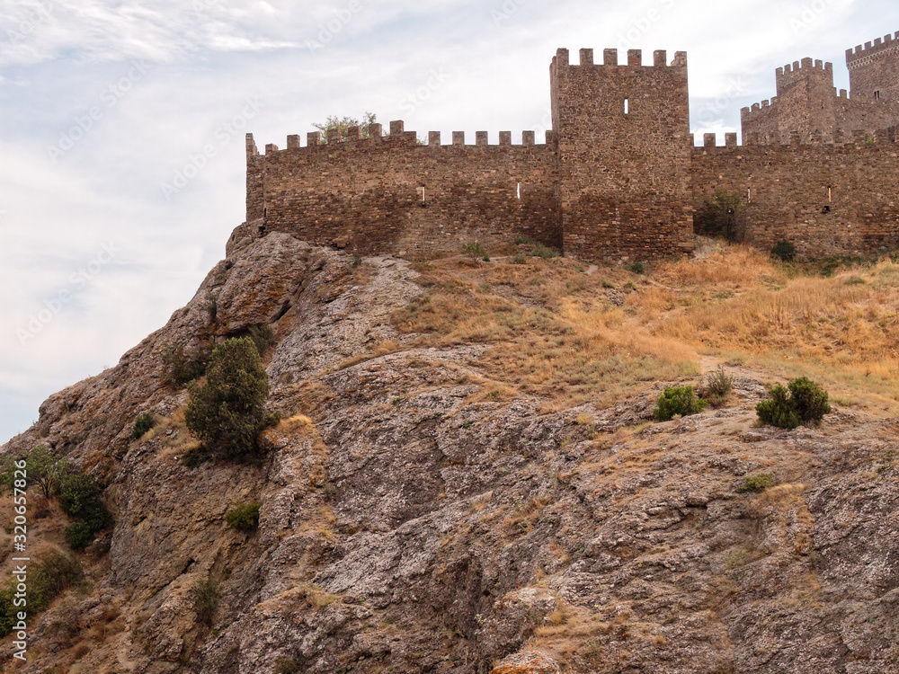 Old medieval Genoese fortress on the top of a cliff    