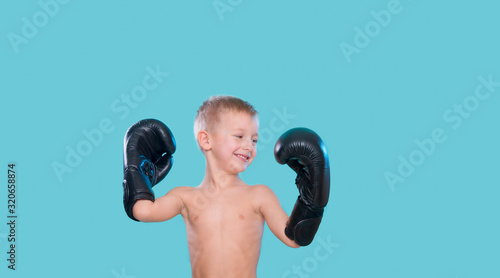 Little kid in the boxing gloves, dreaming about victory, championship. © Augustas Cetkauskas
