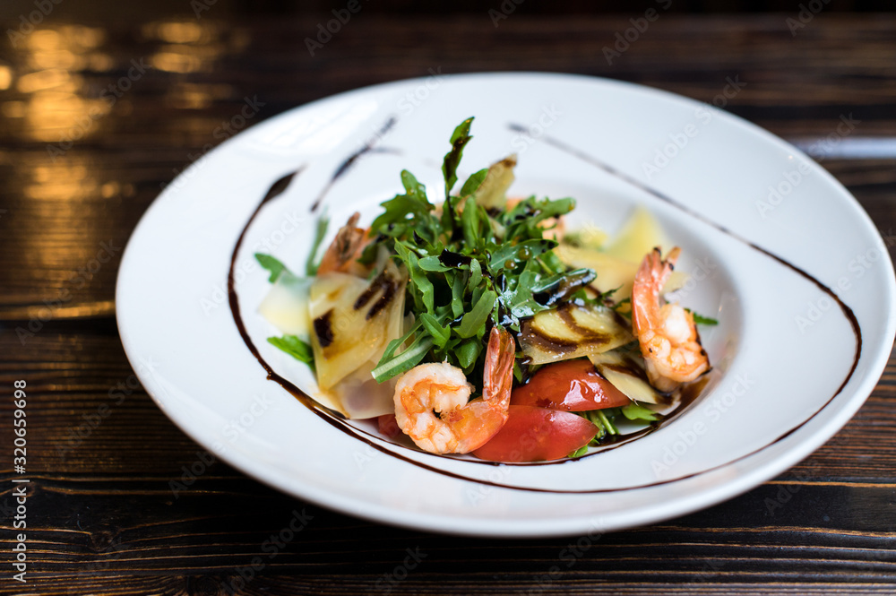 Grilled shrimps and fresh green salad served for lunch Grilled shrimps and fresh green salad served for lunch