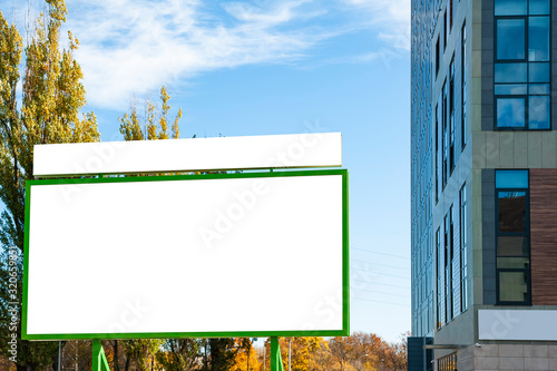Blank white advertising billboard in the front of the modern biuilding photo