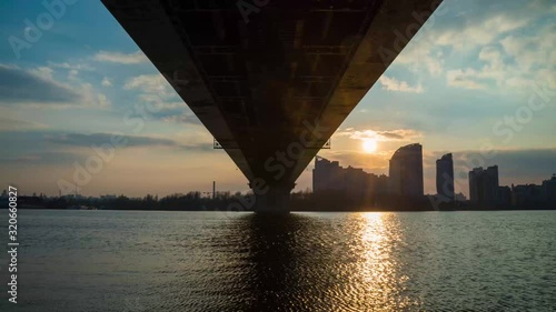 sunset over the river under the bridge