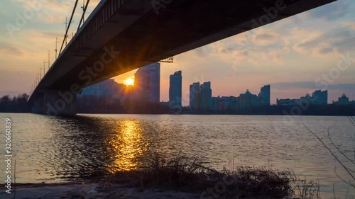 sunset over the river under the bridge