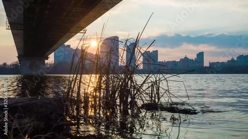 sunset over the river under the bridge