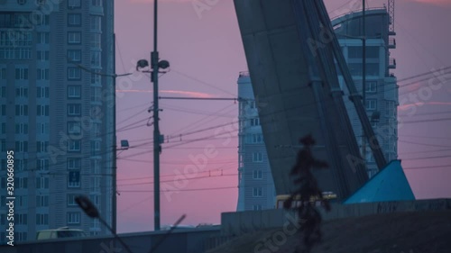 traffic on the background of sunset over the city