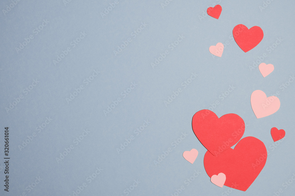 Paper hearts on blue background. For Happy Women's, Mother's, Valentine's Day, birthday greeting card design
