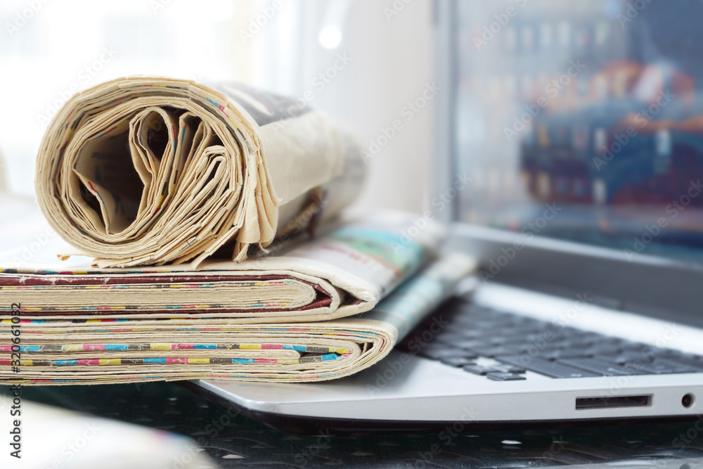 Newspapers and Laptop. Different Concepts for News Network or