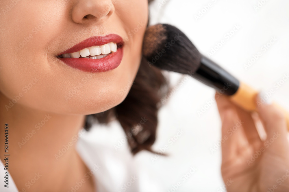 Makeup artist working with beautiful young woman, closeup Makeup artist working with beautiful young woman, closeup