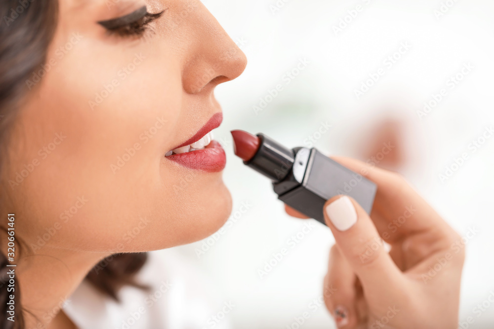 Makeup artist working with beautiful young woman, closeup Makeup artist working with beautiful young woman, closeup