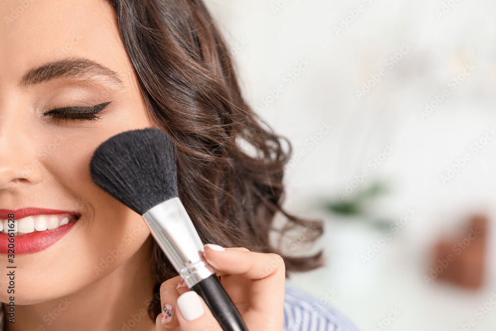 Makeup artist working with beautiful young woman in salon Makeup artist working with beautiful young woman in salon