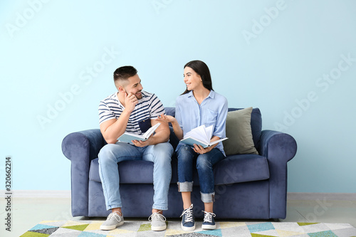 Young couple reading books ...