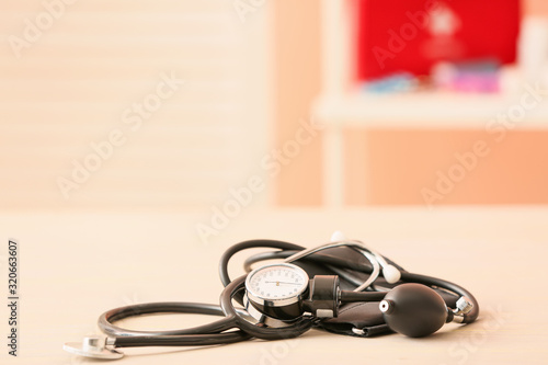 Stethoscope with sphygmomanometer on table in clinic