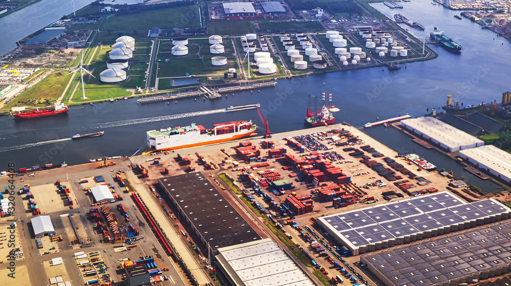 Fototapeta premium aerial shot of port docks and containers for transportation and port ships logistics with tilt-shift focus technique - all trademark elements or logos were cloned out of image