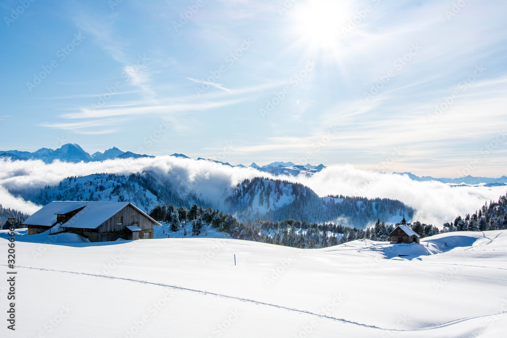 winter wonderland alpine snow covered ski lodge chalet cabin in the swiss mountains. beaut