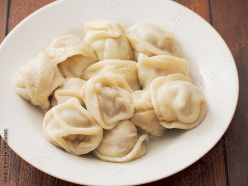 Serving of traditional East European dumplings on a white plate.