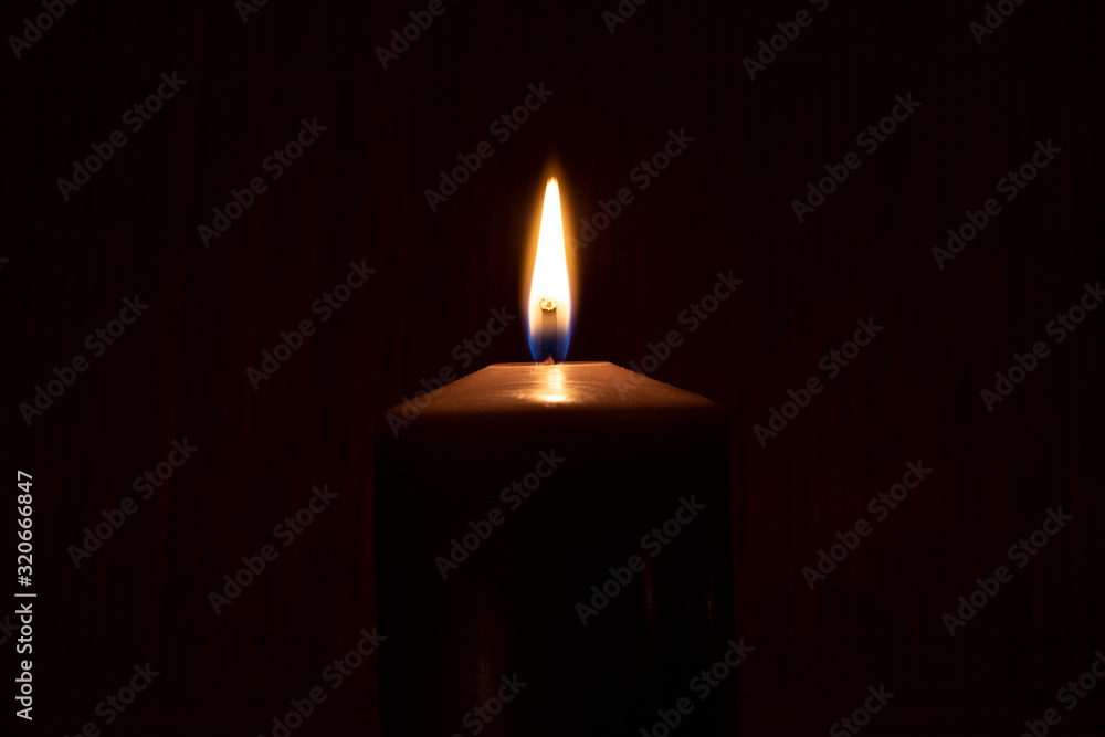 Close up of burning candle in the dark Close up of burning candle in the dark