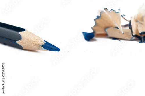 Old green pencil sharpener and pencil isolated on white background.Copy space