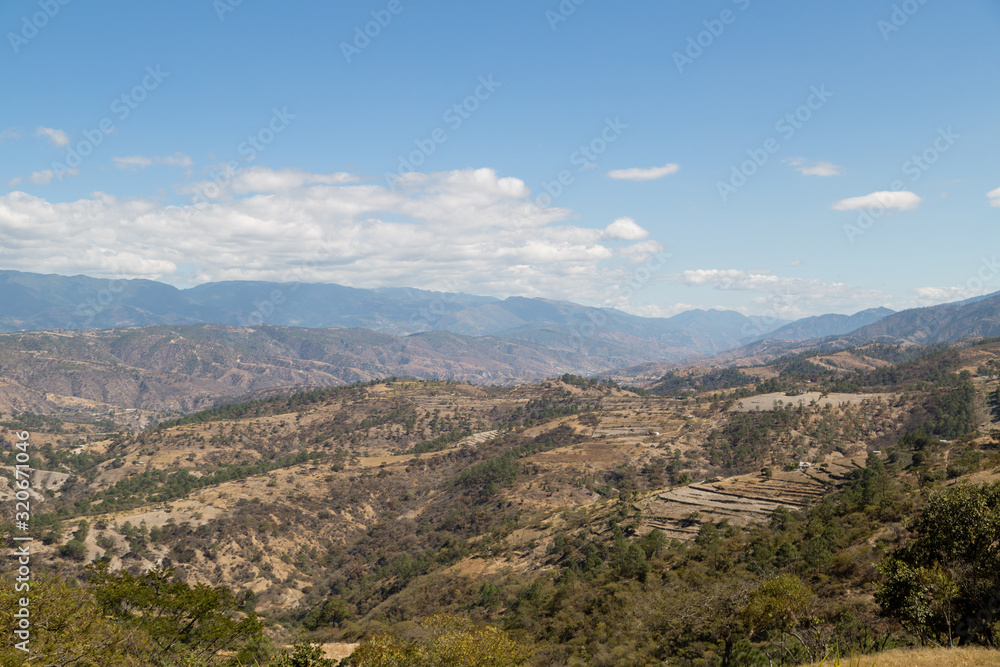 Mountains and hills on the road to Quiche in Guatemala - mountains with few trees - environmental deforestation