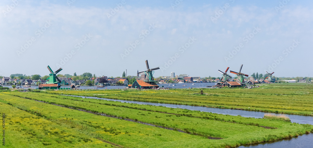 Fototapeta premium Panoramic view of Dutch windmills at Zaanse Schans in Netherlands