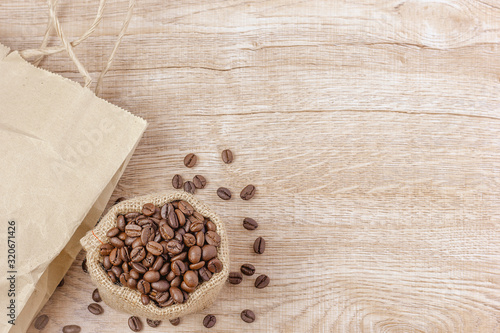 Warm coffee on a wooden plate backgrounds. Vintage backgrounds, Beans backgrounds. Copy space menu.