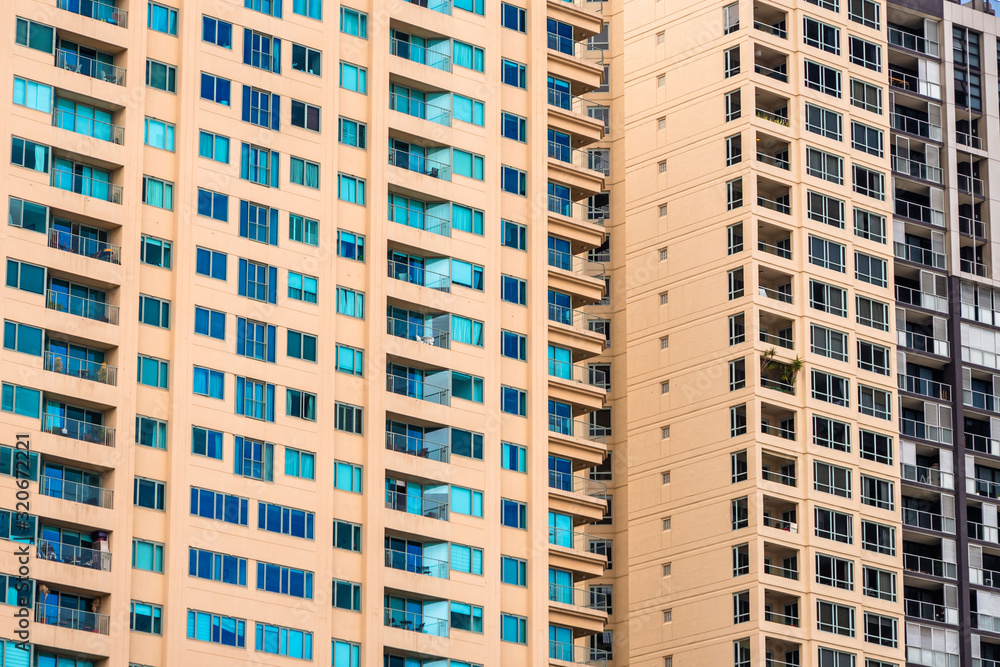 Close up of a yellow block of flats facade packed of windows