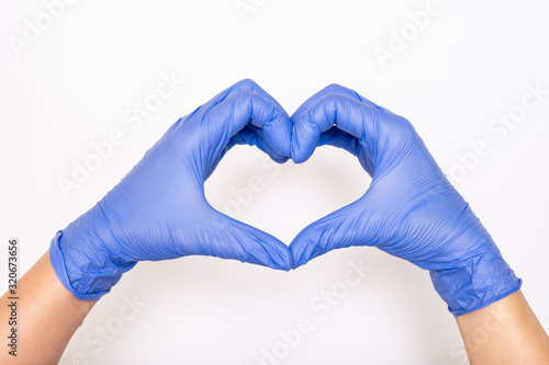 Heart made of latex, nitrile medical gloves for doctor and nurse protection on white background photo