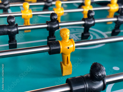 Table football game, Soccer table with yellow and black players © sahachat